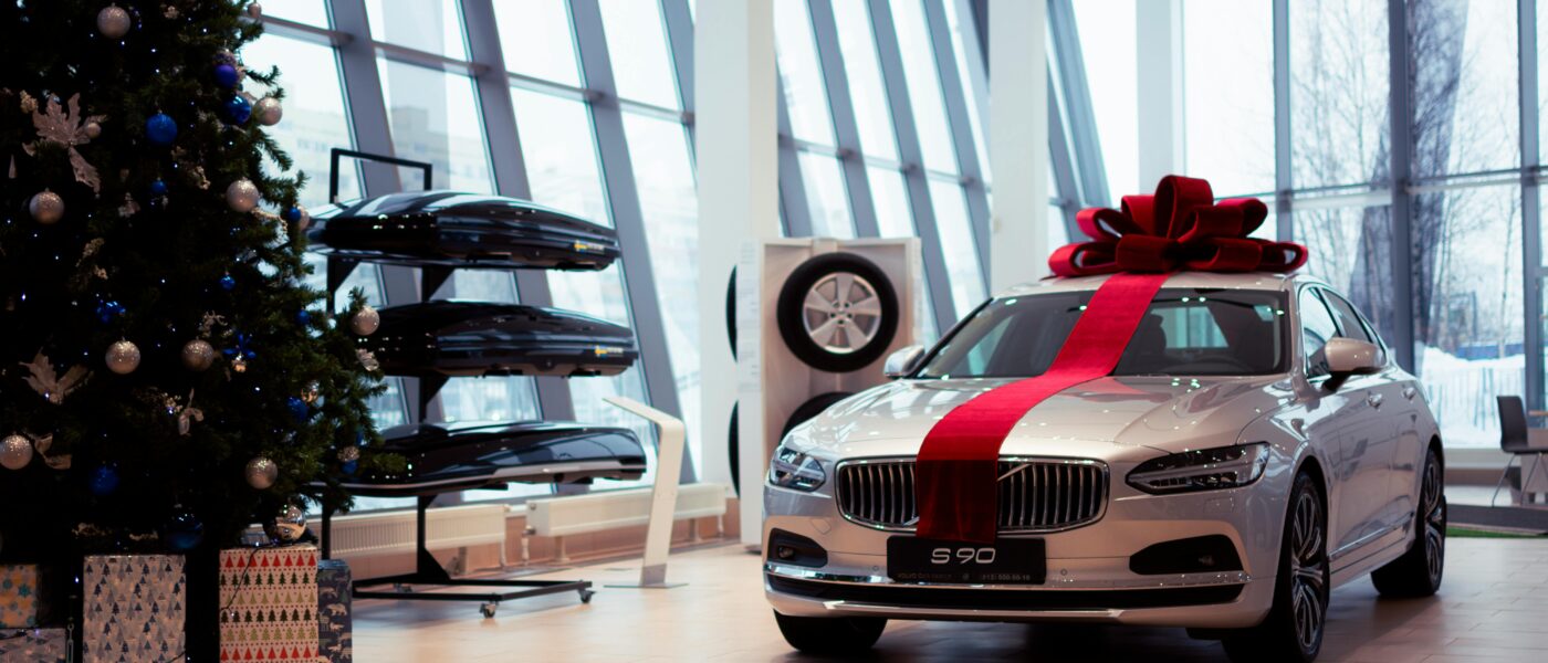 Volvo S90 in showroom decorated with a Christmas tree and gift ribbon for the festive season.