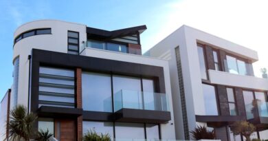 Contemporary luxury home with glass balconies in Poole, UK, showcasing modern architectural design.