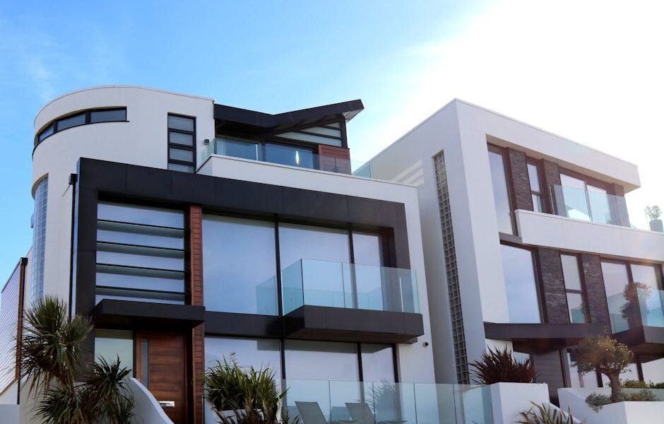 Contemporary luxury home with glass balconies in Poole, UK, showcasing modern architectural design.