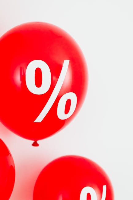 Bright red balloons with a percentage sign symbolizing discounts and sale offers.