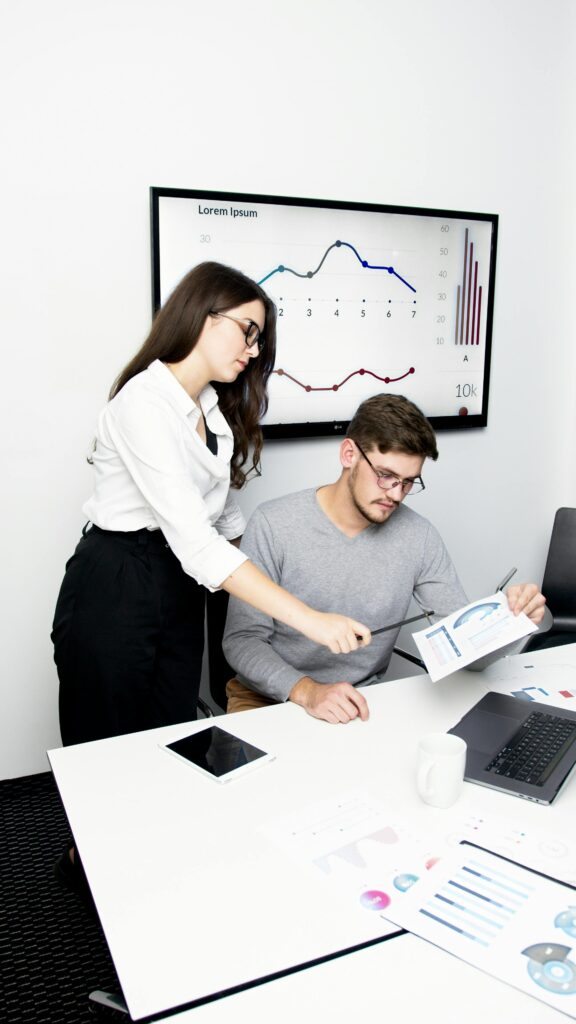 Business team collaborating over data during a meeting in a modern office setting.