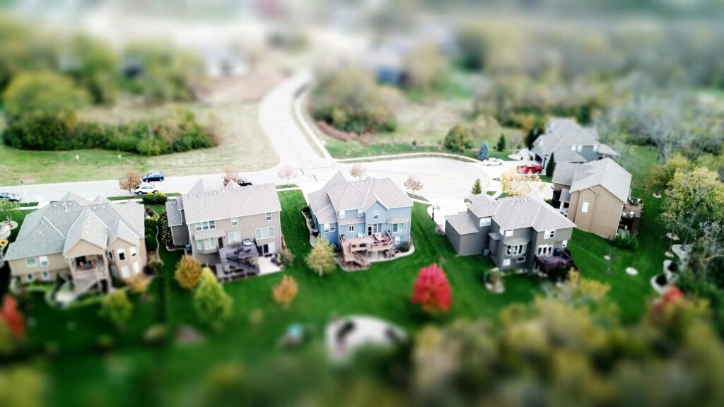 Aerial photo showcasing residential houses in a suburban neighborhood with lush greenery and streets.