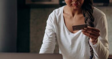 Young woman using laptop and credit card for online shopping at home.