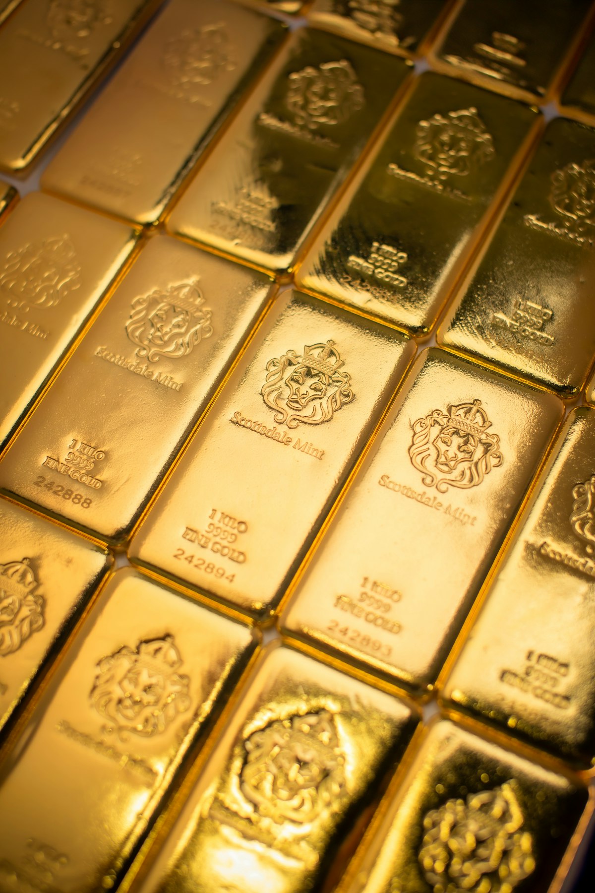 Pile of shining gold bars — precious metals investment guide 2026