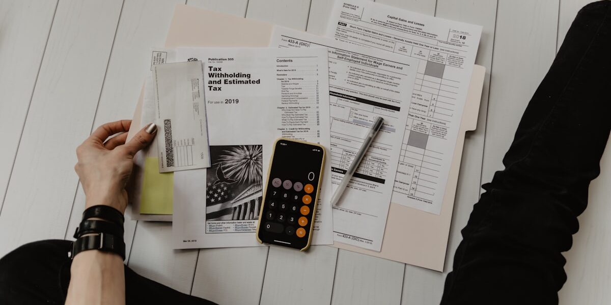 Reviewing financial documents and calculator to rebuild credit after collections