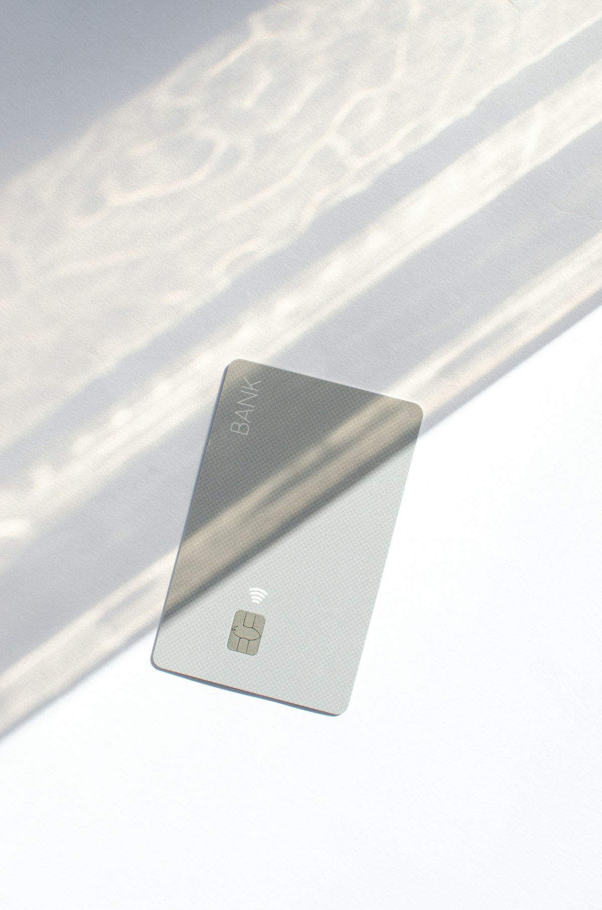 A credit card on a table representing the personal loan vs balance transfer decision for paying off debt