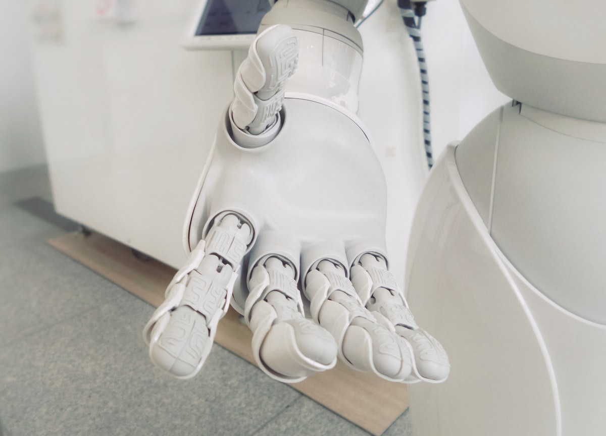 Will AI take my job? Robotic hand symbolizing automation risk in the workplace