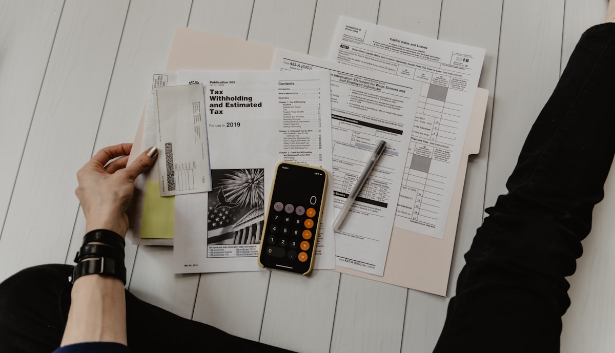 Calculator and paperwork representing how lenders qualify a DSCR loan applicant