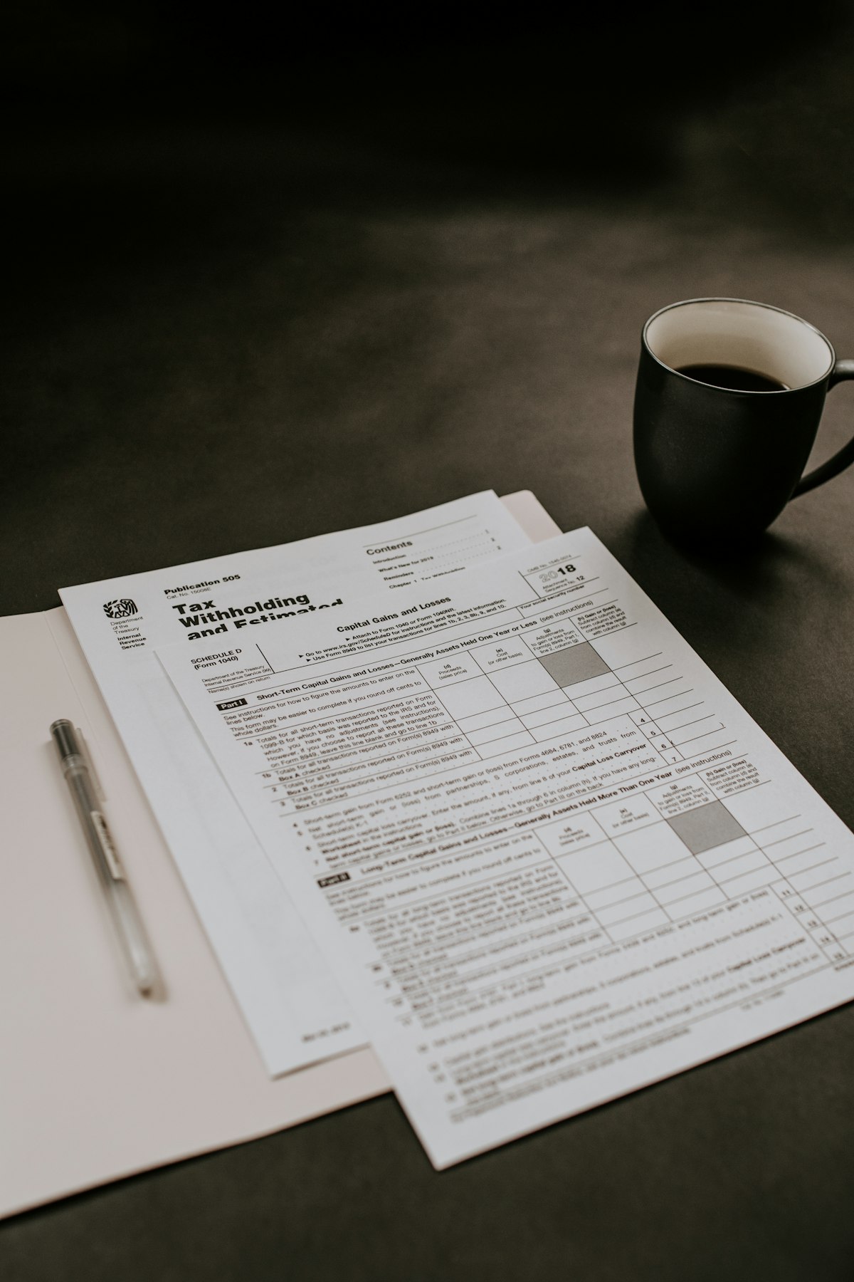 1031 exchange capital gains tax forms and calculator on a desk